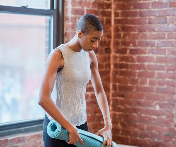 Man practicing balance exercises in a sunlit loft